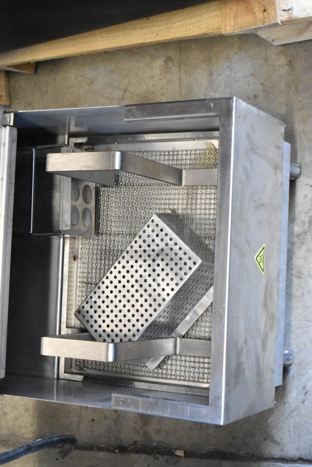 Stainless steel industrial strainer with perforated basket insert, excellent condition, mesh filter, caution label visible.