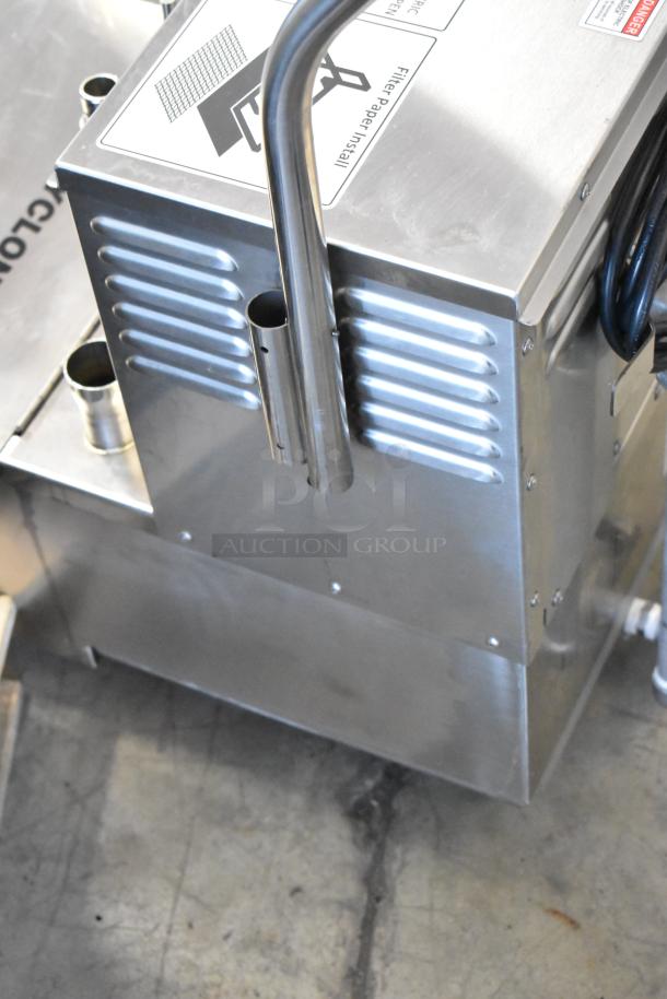 Stainless steel commercial kitchen appliance with visible filter paper installation label, in used condition.