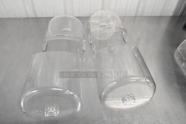 Set of four clear acrylic bakery display covers, featuring flip-up lids and latch mechanisms, in good condition.