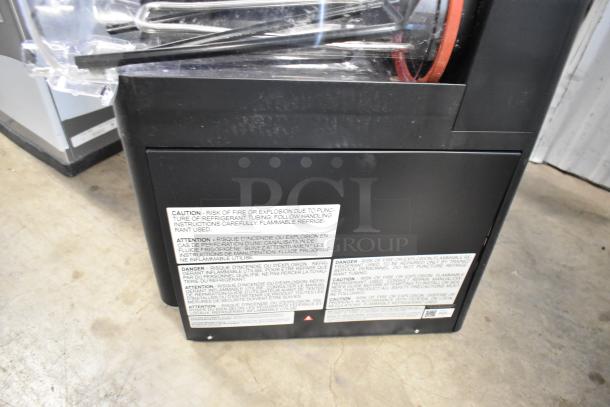 Commercial appliance with caution label about refrigerant tubing, risk of fire or explosion; used condition.