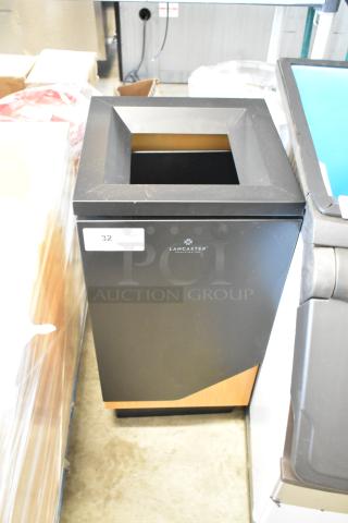 Black Lancaster waste bin with square opening, wood accents, and label indicating lot number 32. Good condition.