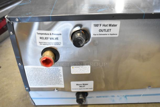 Commercial hot water heater with visible relief valve, 180°F outlet, and warm water inlet. Labels display installation instructions.
