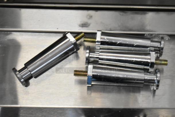 Set of four chrome gas struts with threaded ends, new condition, suitable for mechanical applications.