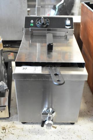 Stainless steel commercial deep fryer with temperature control knob, lid, and spout. Marked with "37 QTY 1" tag.