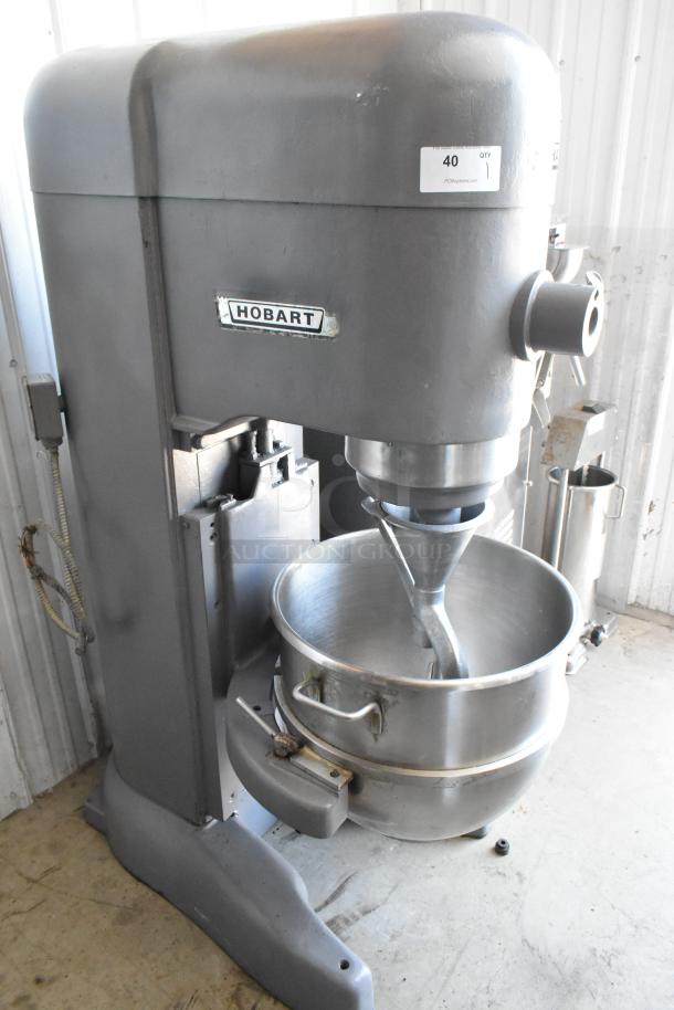 Hobart industrial mixer, stainless steel, model 40, with mixing bowl and dough hook, shows minimal wear, label intact.