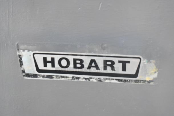 Hobart appliance with visible brand label, showing some wear. Label indicates manufacturer credibility and reliability.