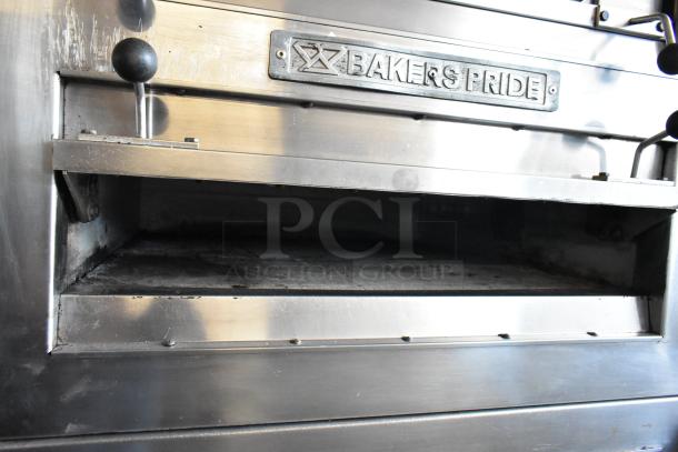 Bakers Pride commercial oven with visible logo, stainless steel exterior, well-used condition, featuring control knobs.