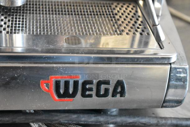 Wega espresso machine with stainless steel finish, featuring Wega logo, in good condition, suitable for commercial use.