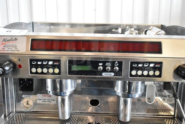 Commercial espresso machine with dual spouts, programmable buttons, boiler pressure gauge, and Absolute branding, in good condition.