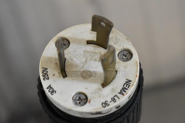 NEMA L5-30 electrical plug, 30A 250V, white and black casing, visible screws, used condition.