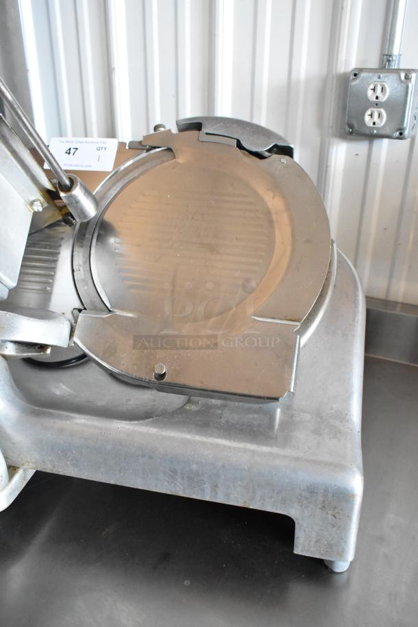 Metal meat slicer with stainless steel blade, moderately used condition. Auction tag indicates item number 47, quantity 1.