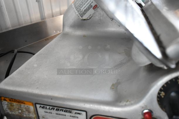Commercial deli slicer by Nella Bros with visible wear. Labels indicate sales, service, and parts availability.