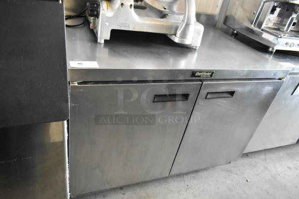 Delfield two-door stainless steel refrigerator cabinet, used condition, model tag visible, durable for commercial use.