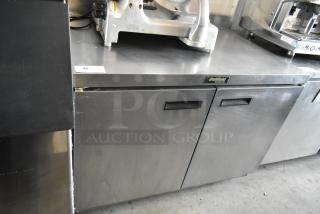 Delfield two-door stainless steel refrigerator cabinet, used condition, model tag visible, durable for commercial use.