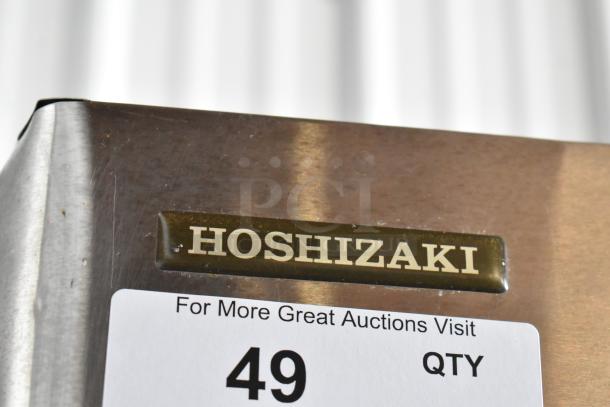 Hoshizaki commercial ice maker corner with logo plate, showing minimal wear. Auction number label visible, marked "49".