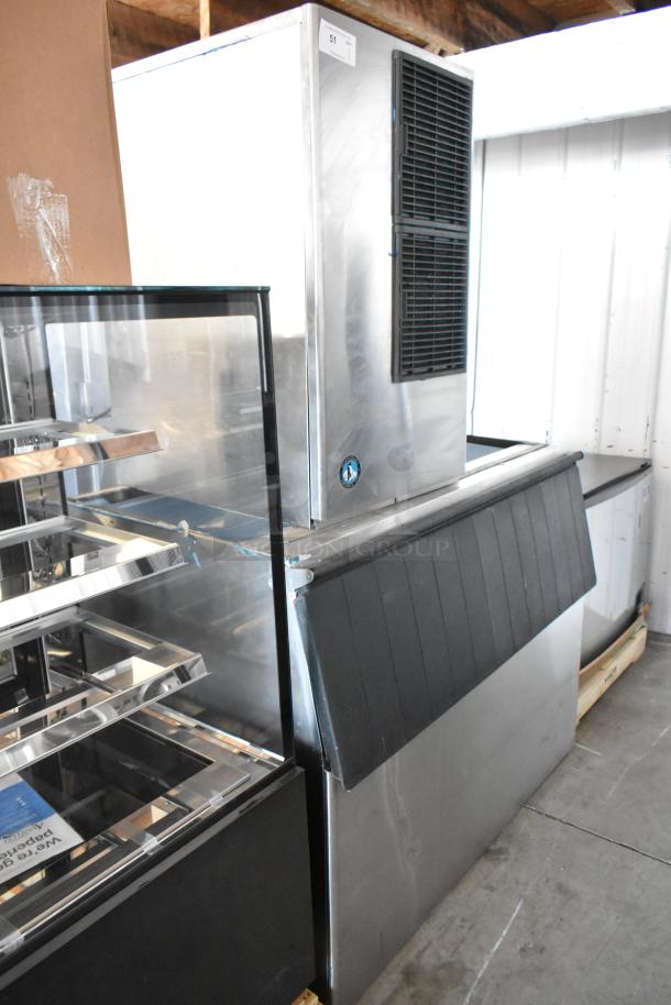 Commercial stainless steel beverage cooler with glass display, ice machine, and ventilation panel. Good condition.