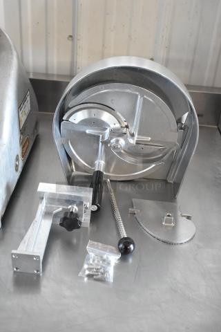 Commercial meat slicer parts in metal, including blade assembly and handle. Includes mounting bracket and screws. Good condition.