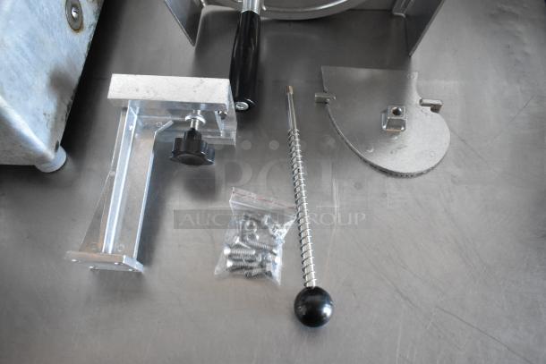 Metal lever assembly with black handle, adjustable mounting bracket, and bag of screws on a silver surface. Components in good condition.