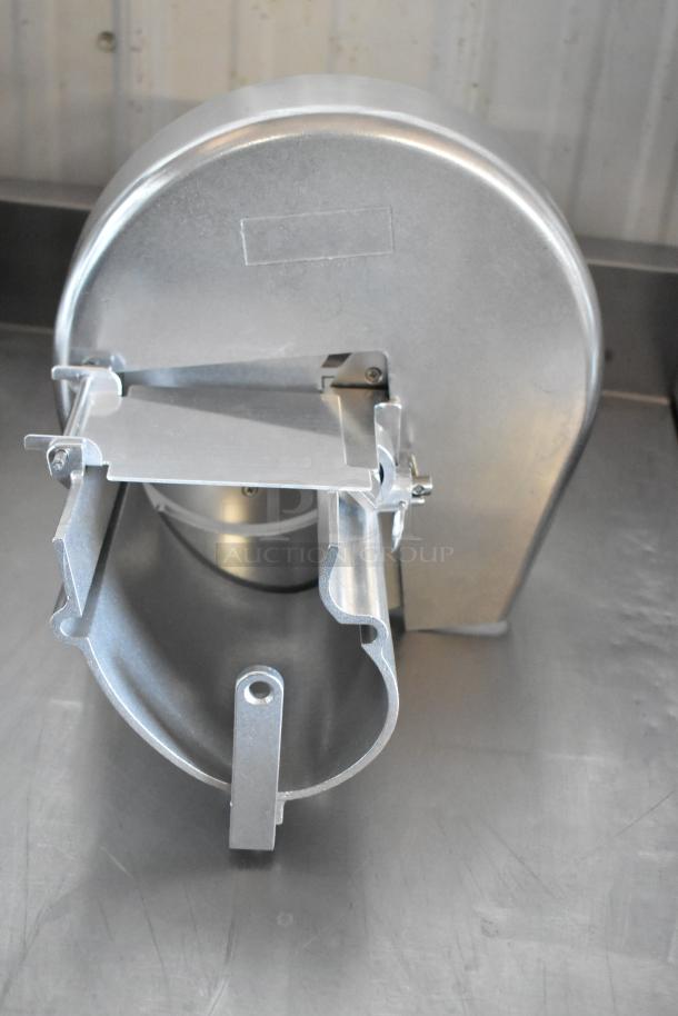Stainless steel industrial duct reducer, detachable components, new condition, mounted on a metal surface.
