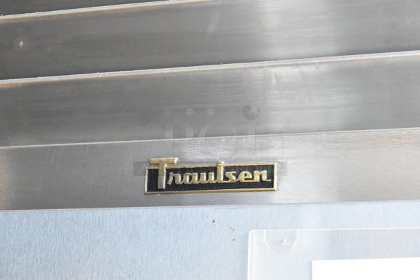 Traulsen stainless steel refrigerator with logo. Durable construction, visible brand marking, excellent condition.