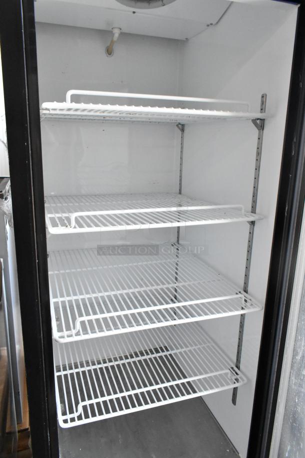 Commercial upright display refrigerator with glass door, four adjustable shelves, white interior, good condition.