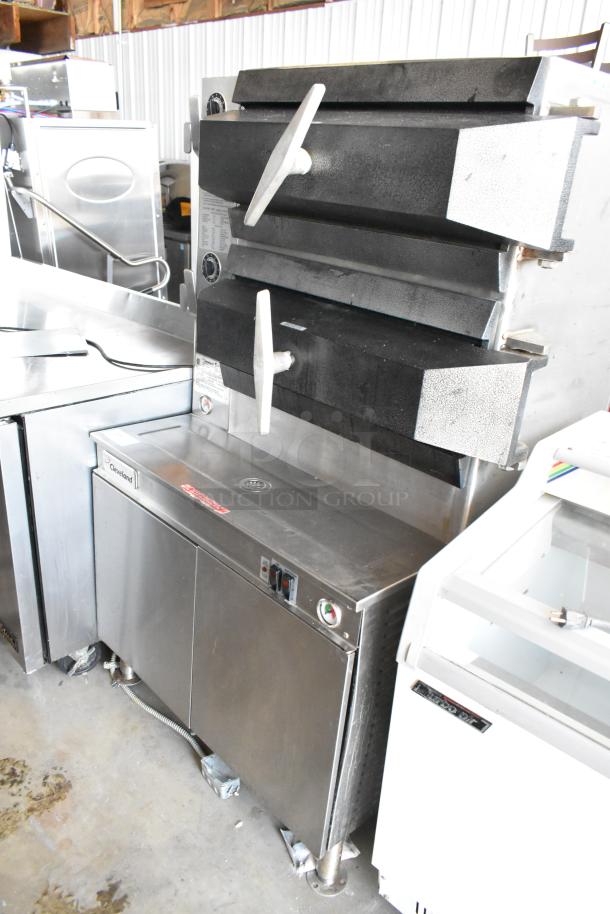 Stainless steel Cleveland commercial steamer with dual compartments, manual handles, and visible gauge, in good condition.