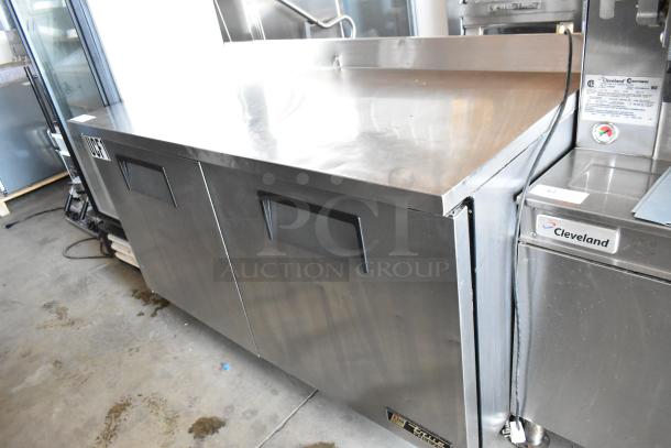Stainless steel commercial refrigeration unit with dual doors. Brand: True. Excellent condition, ideal for restaurant use.