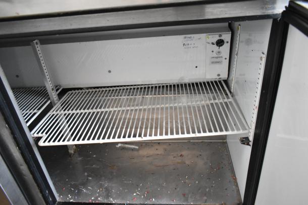 Commercial refrigerator interior with wire shelving and control panel. Visible markings include "High" and "Push." Good condition.