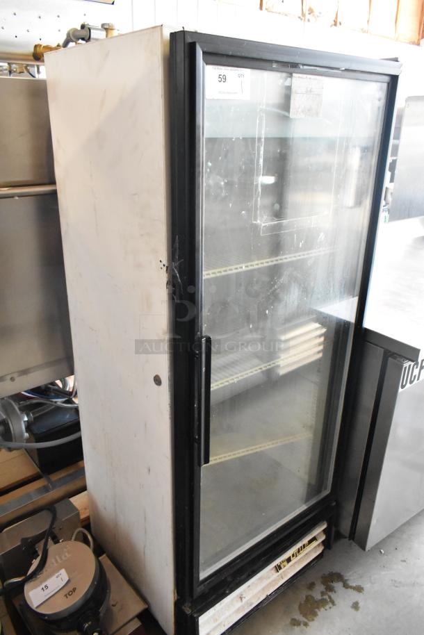 Commercial glass-door refrigerator, metal casing, shelving inside, visible wear, auction tag "59 QTY 1", used condition.
