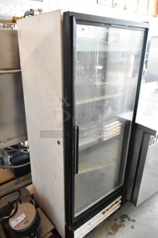 Commercial glass-door refrigerator, metal casing, shelving inside, visible wear, auction tag "59 QTY 1", used condition.