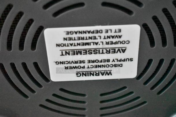 Appliance base with vent holes, warning label stating "Disconnect power supply before servicing" in English and French.