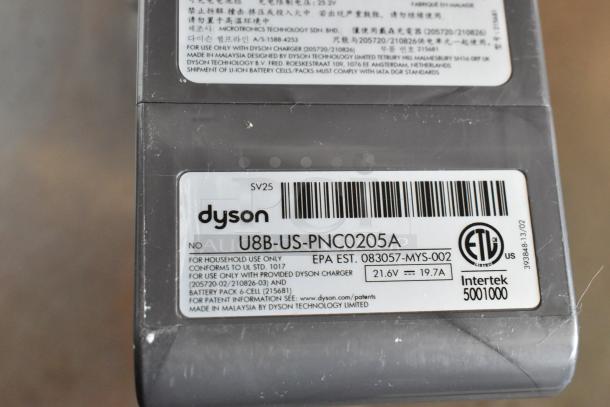 Close-up of a Dyson battery pack label, model U8B-US-PNC0205A, 21.6V, 19.7A, for household use, made in Malaysia.
