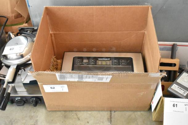 VacPak-It vacuum sealer in cardboard box, displaying digital control panel. Box labeled with auction tag "62 QTY 1".