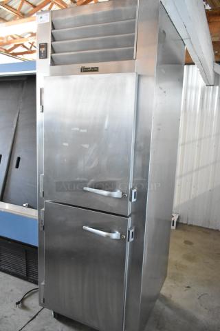 True Refrigeration stainless steel commercial freezer with dual doors, clean exterior, digital display, auction tag number 64.
