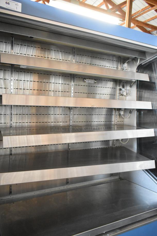 Stainless steel open display refrigerator with multiple shelves; auction tag labeled "66" indicates inventory number.