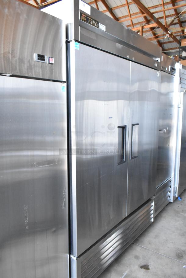 Stainless steel commercial refrigerator with double doors, True brand, model T-49F. Visible scratches, large capacity, energy-efficient.