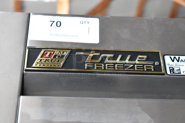 True Freezer with True Manufacturing Co. label, stainless steel finish. Auction tag "70 QTY 1" visible.