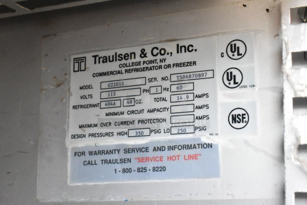 Traulsen commercial refrigerator label, model G22010, 115 volts, 404A refrigerant, UL and NSF certified, warranty info included.