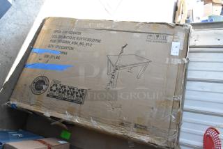 Cardboard box with a rustic pine table, UPC 889142264699, weighing 57 lbs. Box shows signs of wear and tear.