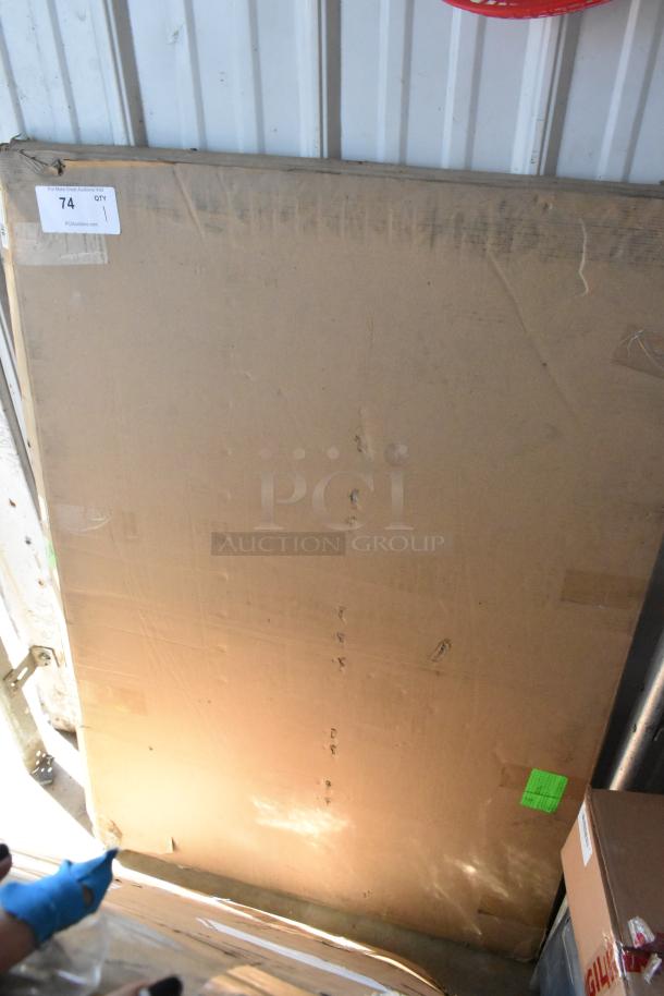 Large cardboard box with auction label 74, QTY 1. Box shows signs of wear and handling.