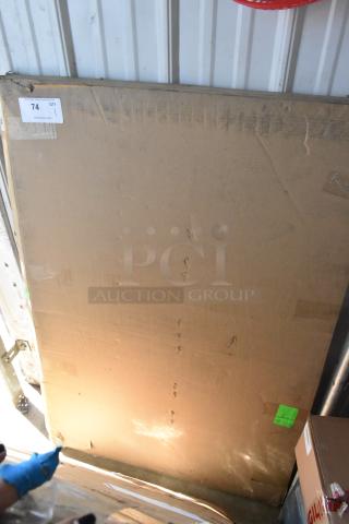 Large cardboard box with auction label 74, QTY 1. Box shows signs of wear and handling.