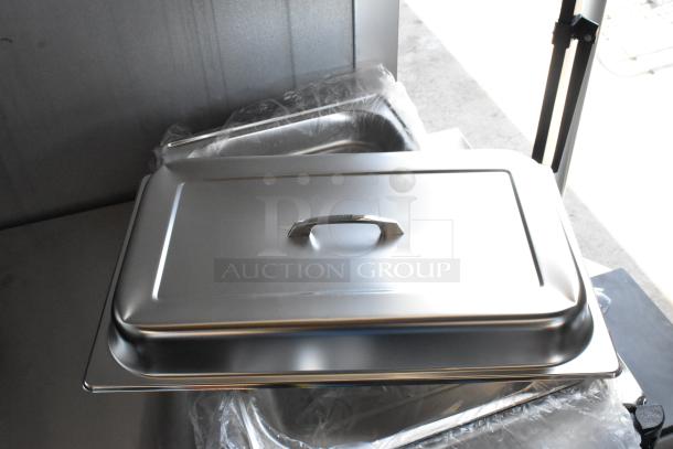 Stainless steel chafing dish with lid and handle, unused, wrapped in plastic. Ideal for catering and buffet service.