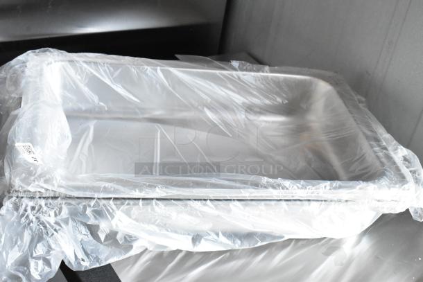 Stainless steel baking tray wrapped in plastic, in new condition. Tag visible, indicating item number 203.