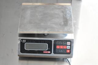 Torrey L-EQ Series digital scale with stainless steel platform, displays kg/lb/oz, used condition, functional keypad.