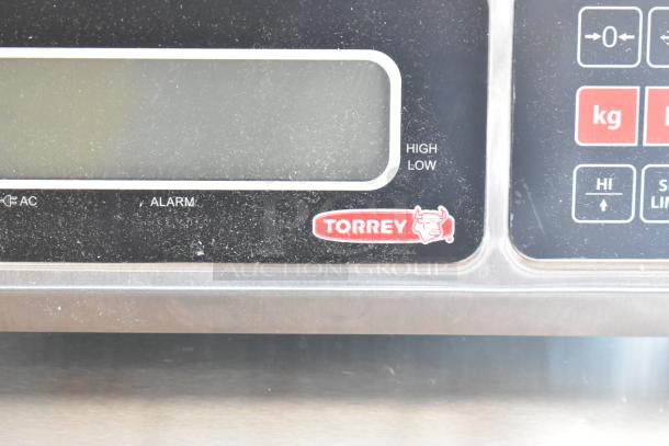 Torrey electronic scale display panel, showing brand logo and controls for high/low settings, in used condition.