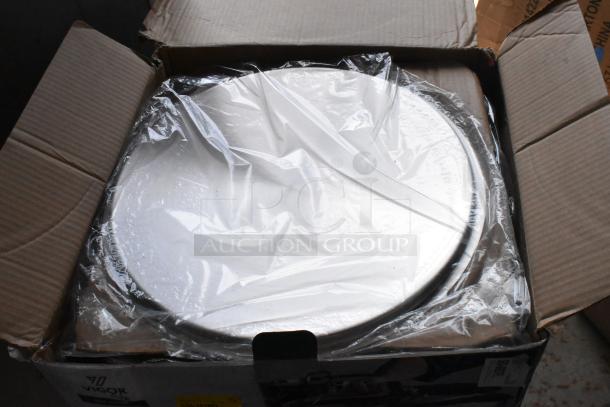 Box of new Vigor stainless steel cooking pans, sealed in plastic, showing durable construction and brand logo.