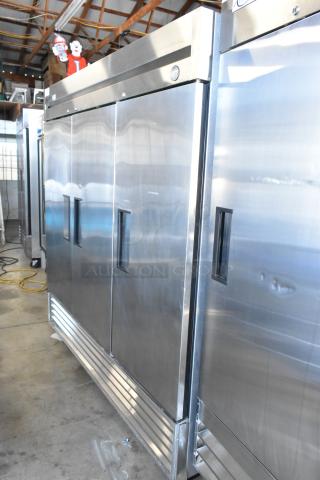 Commercial stainless steel refrigerator, three-door, industrial use, visible thermometer, good condition, minor wear.