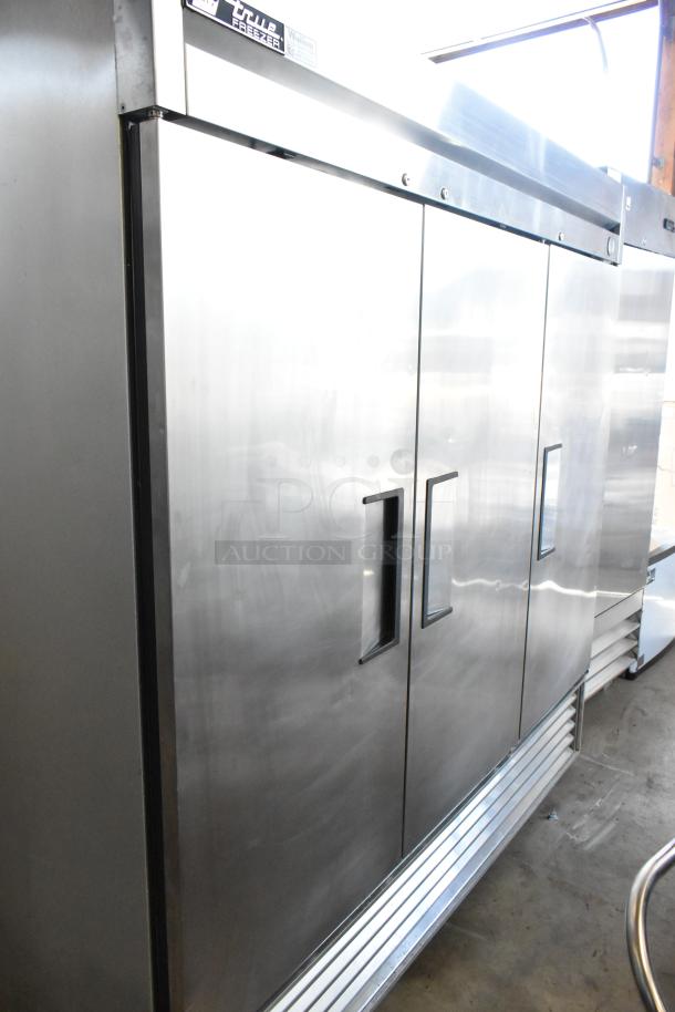 Commercial stainless steel triple-door freezer. True brand label on top. Excellent condition, ideal for restaurant use.
