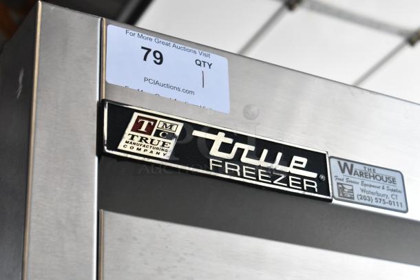 Stainless steel True freezer by True Manufacturing Company, model with visible labels, in good condition. Auction item 79.