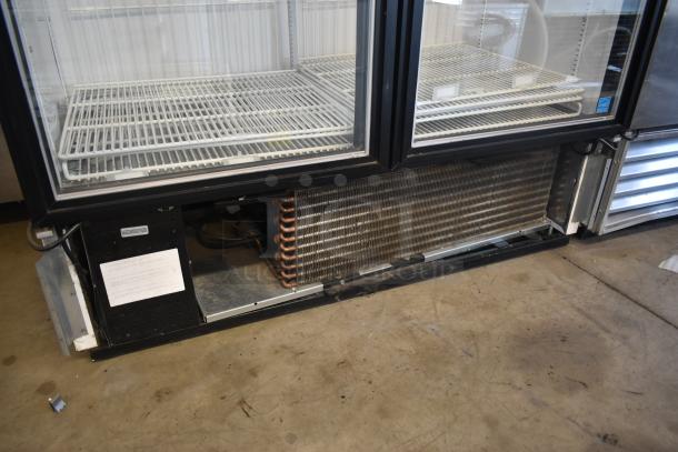 Commercial glass-door refrigerator in used condition, showing interior shelves and cooling components. Labels with specifications visible on the casing.